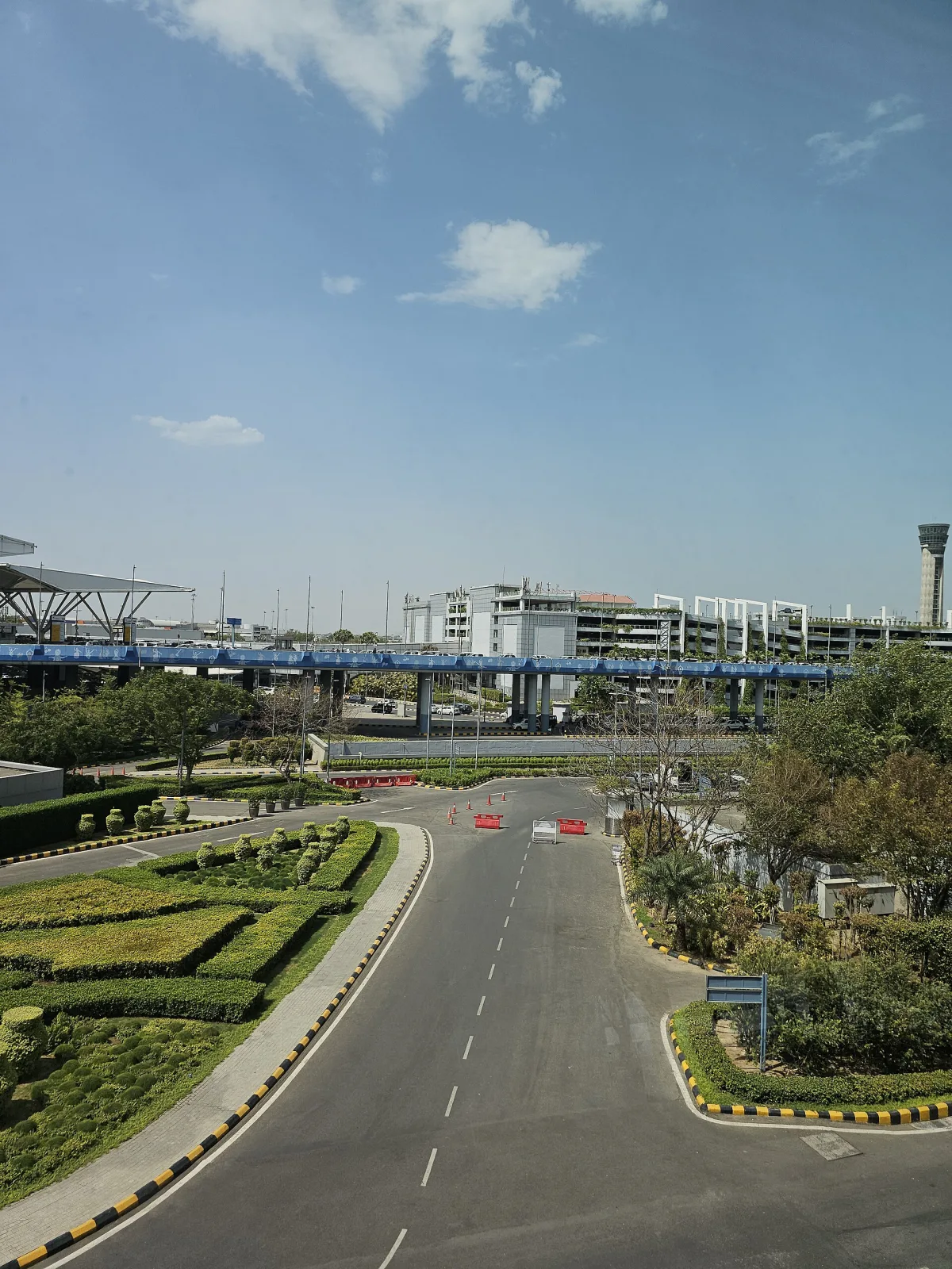 Landscaped roadway and terminal buildings at Delhi International Airport